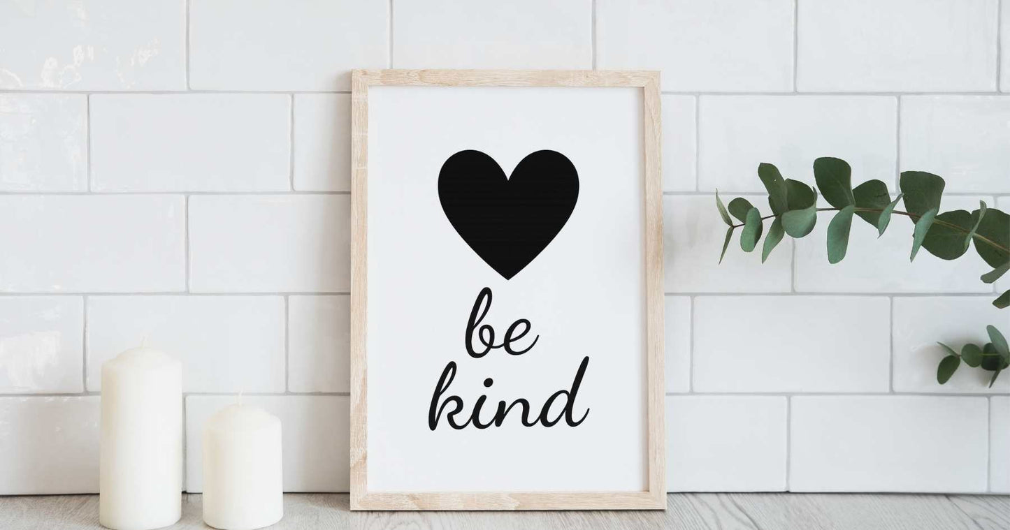 A free downloadable wall art design with the words be kind in a soft script font and a minimalist black heart. Created to support emotional wellbeing and everyday self love.