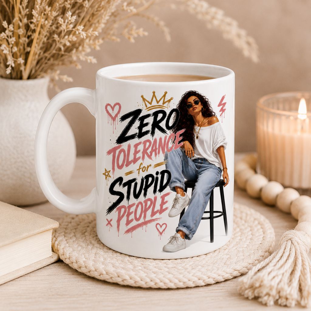 11oz white ceramic funny mug for women displayed in a cosy modern boho home setting featuring the quote "Zero Tolerance For Stupid People" with stylish fashion inspired woman artwork. White mug with white inside and handle, design printed on both sides and small subtle Pypog logo on the side. Funny coffee mug and sarcastic mug perfect as a best friend gift, birthday gift for her, coworker gift, office gift, work bestie gift and novelty present for women with attitude.