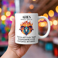 A white 11oz coffee mug featuring a bold Aries-themed design. The artwork showcases a fierce ram’s head engulfed in flames, with the Aries zodiac symbol glowing above it. The fiery colour palette reflects Aries' passionate and direct personality. Below, the sassy text reads: "Too blunt? Fuck that! Sugarcoating is for cupcakes, not Aries." A cheeky, rude astrology gift for Aries star sign lovers.