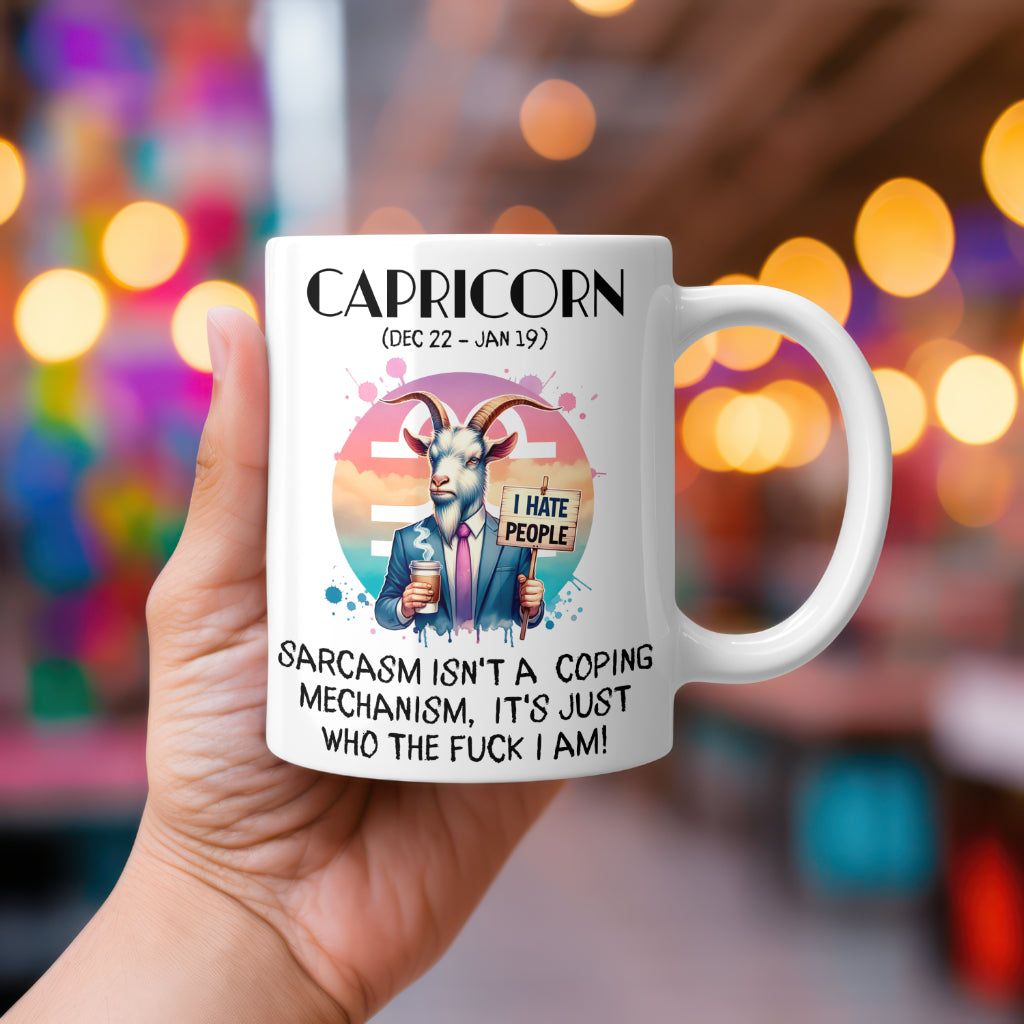A white 11oz coffee mug featuring a bold Capricorn-themed design. The artwork depicts a well-dressed goat in a suit, holding a coffee cup and a sign that reads, "I hate people," against a stylized Capricorn zodiac background. Below, the sarcastic text states: "Sarcasm isn't a coping mechanism, it's just who the fuck I am!" A hilarious, rude astrology gift for Capricorn star sign lovers.