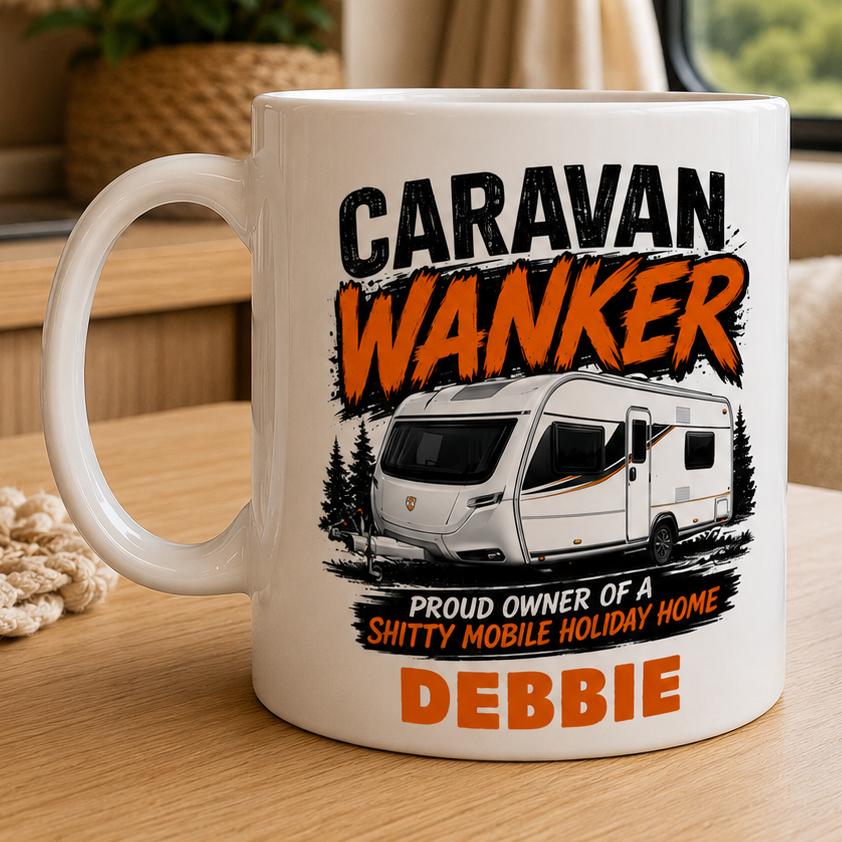 Mug with 'Caravan Wanker' design on a table with a scenic background