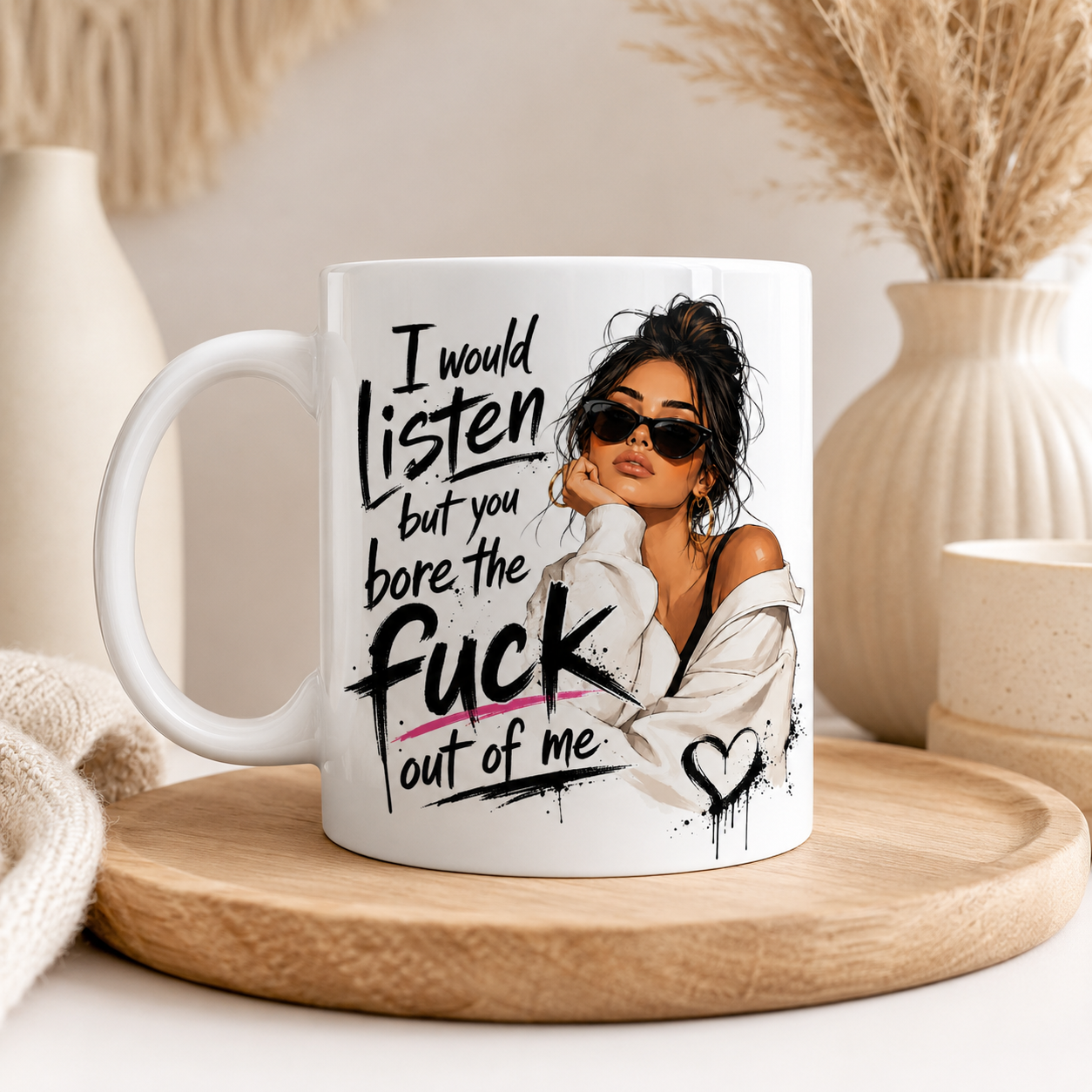 White 11oz ceramic mug with pink inside and handle featuring the funny quote “I Would Listen But You Bore The Fuck Out Of Me” alongside a stylish illustrated woman design. Displayed in a cosy boho home setting with neutral décor and candles. Funny sarcastic mug for women, rude coffee mug, novelty mug, best friend gift, sister gift, coworker present and cheeky birthday gift idea printed in the UK.