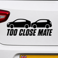 Funny vinyl decal car sticker with two cars and 'Too Close Mate' text on a white car.