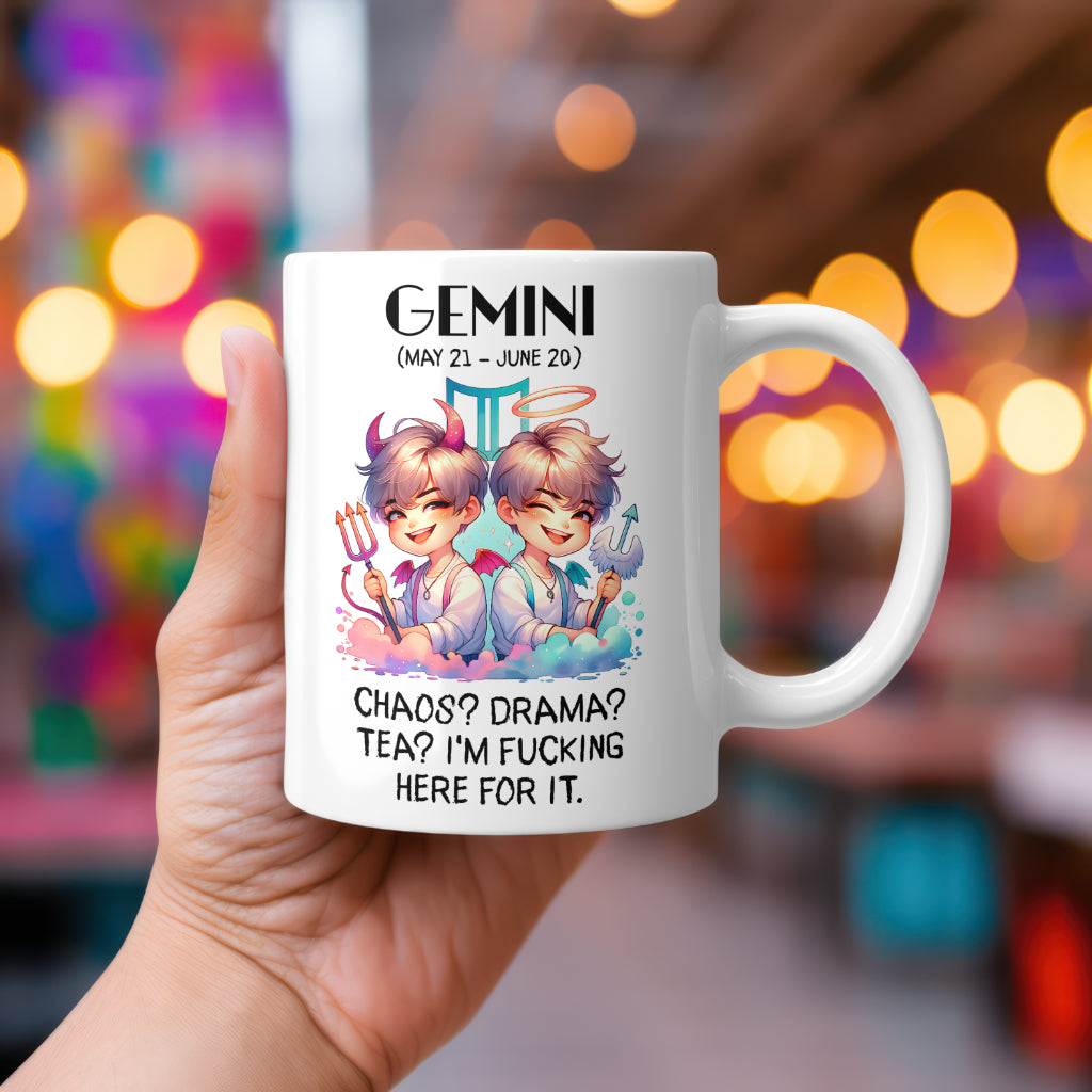 A white 11oz coffee mug featuring a bold Gemini-themed design. The artwork showcases twin figures with playful expressions, one with devil horns and a trident, the other with an angel halo and wings, representing the duality of Gemini. The background includes the Gemini zodiac symbol. Below, the sassy text reads: "Chaos? Drama? Tea? I’m fucking here for it." A cheeky, rude astrology gift for Gemini star sign lovers.