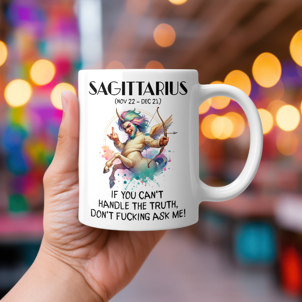 A white 11oz coffee mug featuring a bold Sagittarius-themed design. The artwork showcases a centaur with rainbow hair and a cheeky expression, holding a bow and arrow while making a rock 'n' roll hand gesture. Below, the sassy text reads: "If you can't handle the truth, don't fucking ask me!" A hilarious, rude astrology gift for Sagittarius star sign lovers.