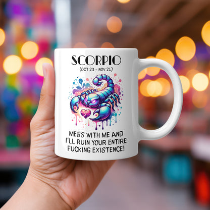 A white 11oz coffee mug featuring a bold Scorpio-themed design. The artwork showcases a fierce, vibrant scorpion with neon-style colours and dripping paint effects, symbolizing the Scorpio zodiac sign. Below, the intense text reads: "Mess with me and I'll ruin your entire fucking existence!" A sassy, rude astrology gift for Scorpio star sign lovers.