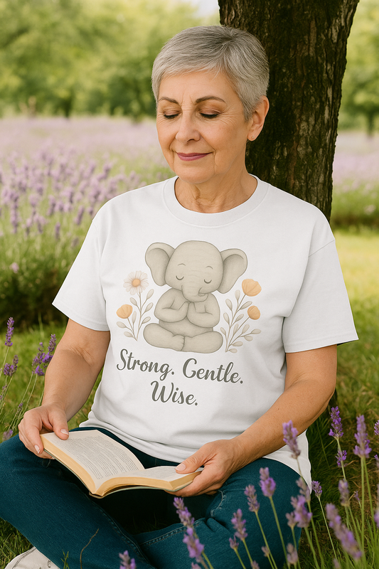 Woman reading outdoors in lavender field wearing a mindfulness elephant t-shirt with Strong Gentle Wise quote, ideal yoga lover gift, positive vibes tee, boho fashion shirt, peaceful meditation clothing, mental health reminder top, self-care gift idea, animal graphic tee.
