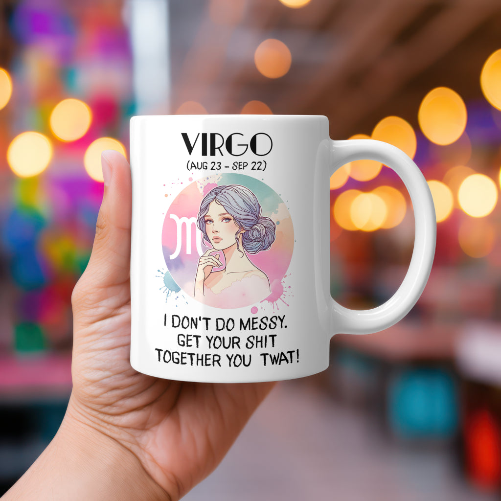 A white 11oz coffee mug featuring a bold Virgo-themed design. The artwork showcases a sophisticated woman with pastel blue hair styled in a neat bun, set against a soft pink and green Virgo zodiac symbol background. Below, the no-nonsense text reads: "I don’t do messy. Get your shit together, you twat!" A witty, rude astrology gift for Virgo star sign lovers.