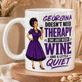 White mug with a graphic of a woman in a purple dress holding a glass of wine, text 'Georgina doesn't need therapy, she just needs wine and a little quiet', on a wooden coaster with decorative elements.
