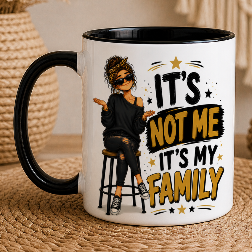 Mug with a design and text 'It's not me, it's my family' on a woven mat.