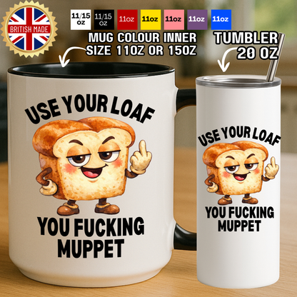 White ceramic mug with black handle and inner, showing a cartoon loaf character making a rude gesture with the phrase use your loaf you f*cking muppet, next to a matching 20oz stainless steel tumbler.